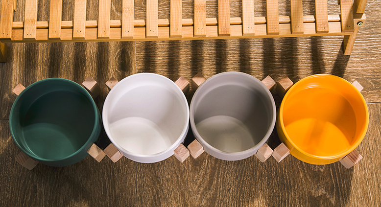 Elevated ceramic pet bowl with wooden stand